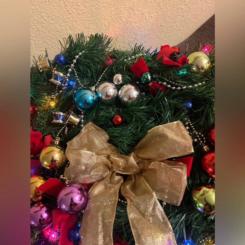 Festive Holiday Wreath with Gold Bow and Multicolor Ornaments
